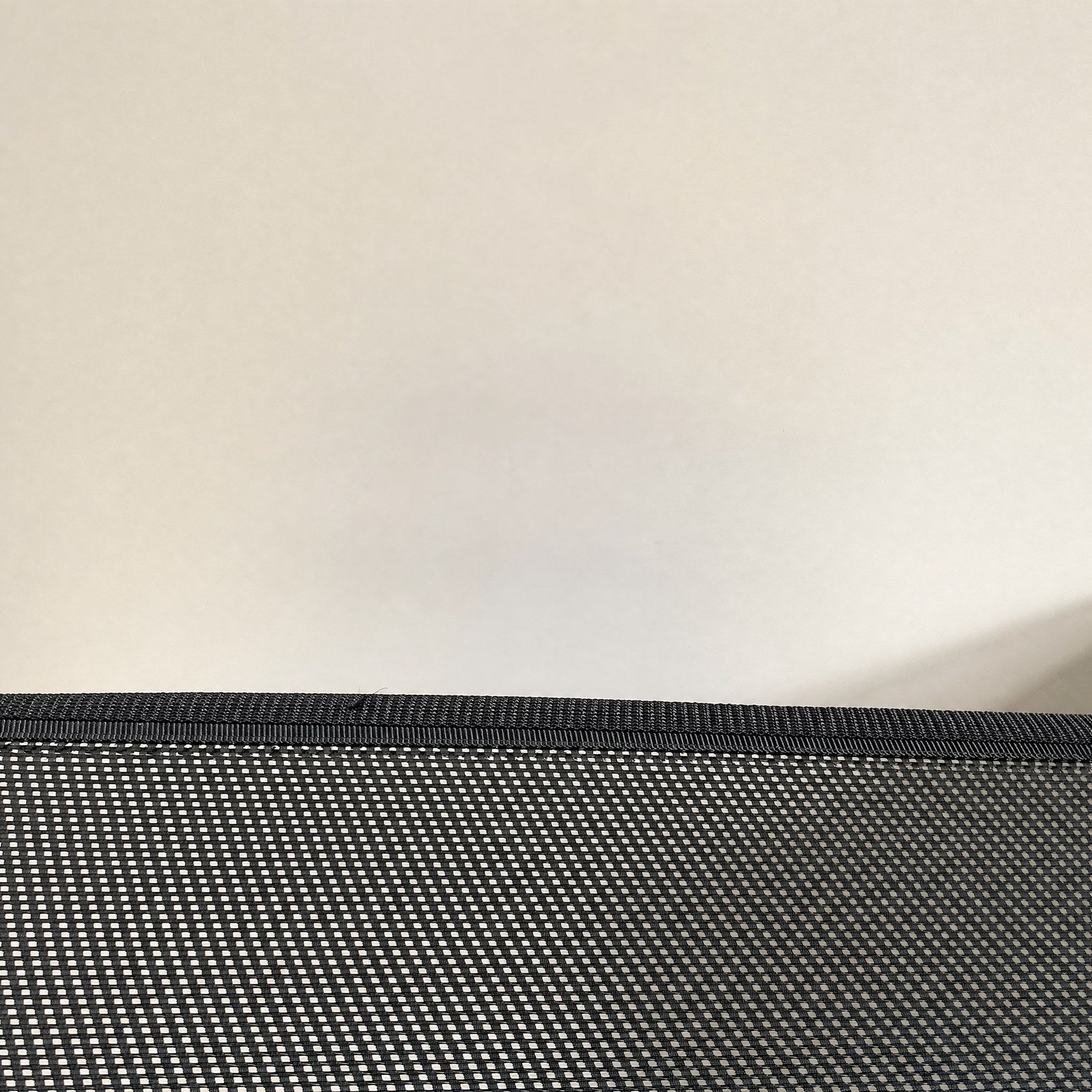 Close-up of the mesh, its open weave and bound edge