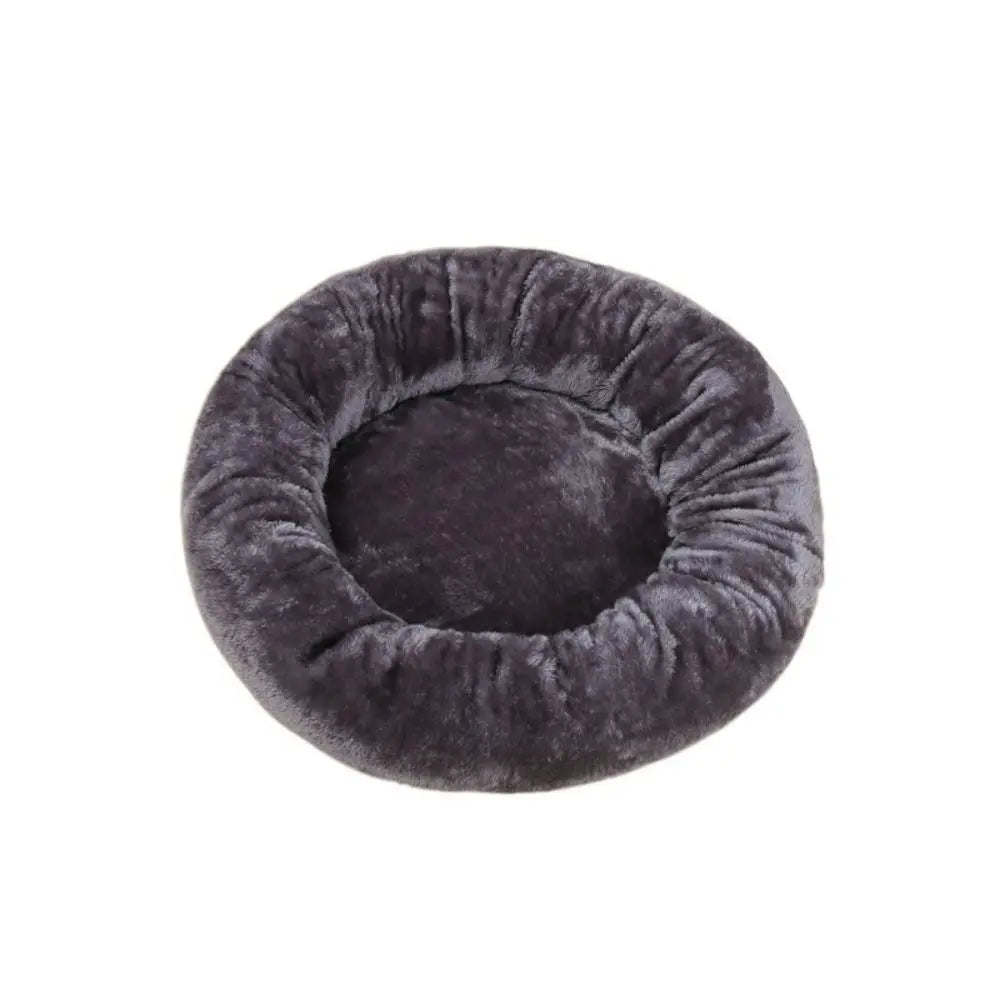 A dark charcoal plush donut dog bed