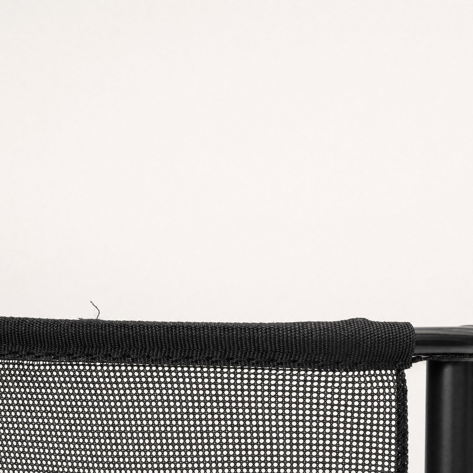 Close-up of the mesh, its open weave and bound edge