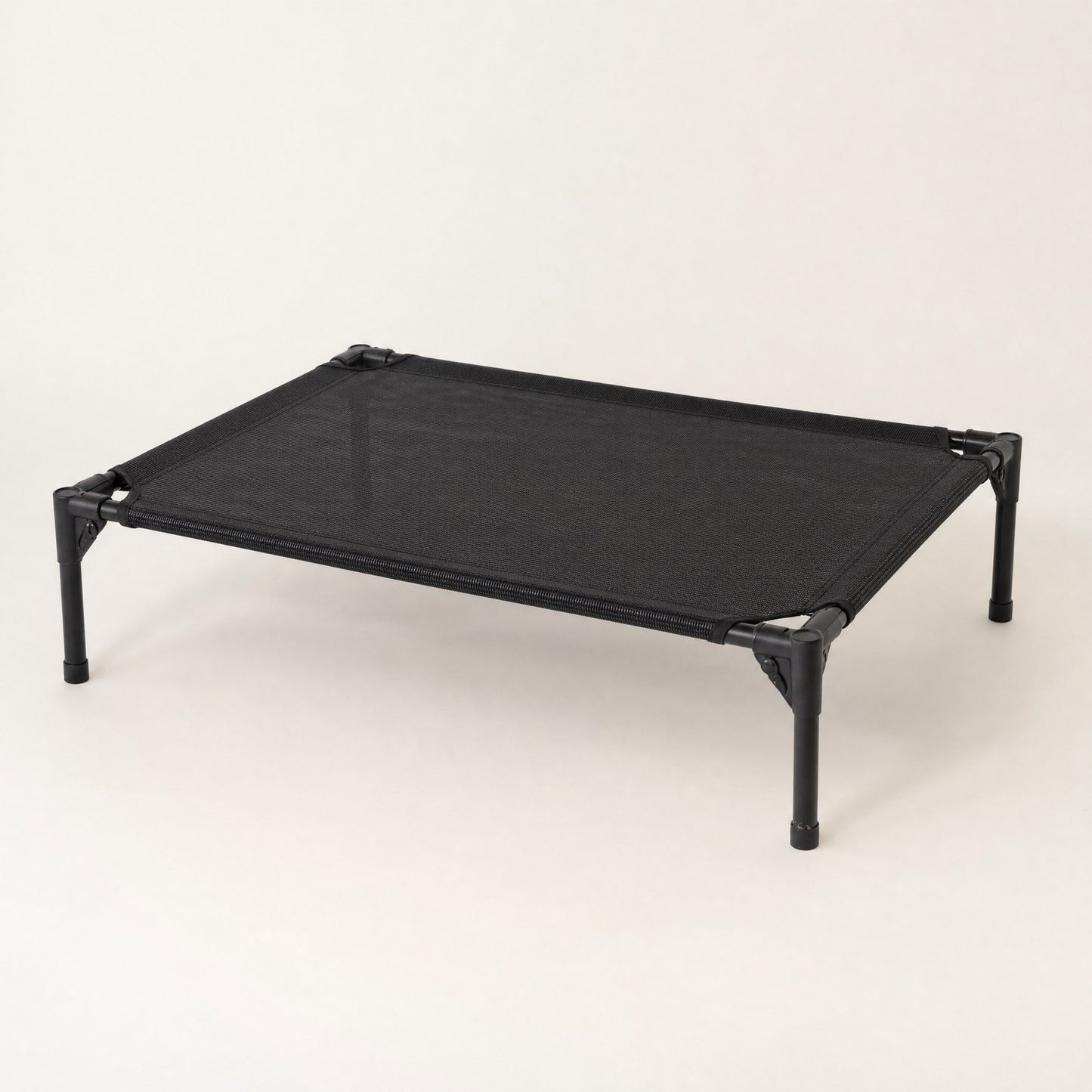 The folding cot seen at an angle, hinges and gap visible