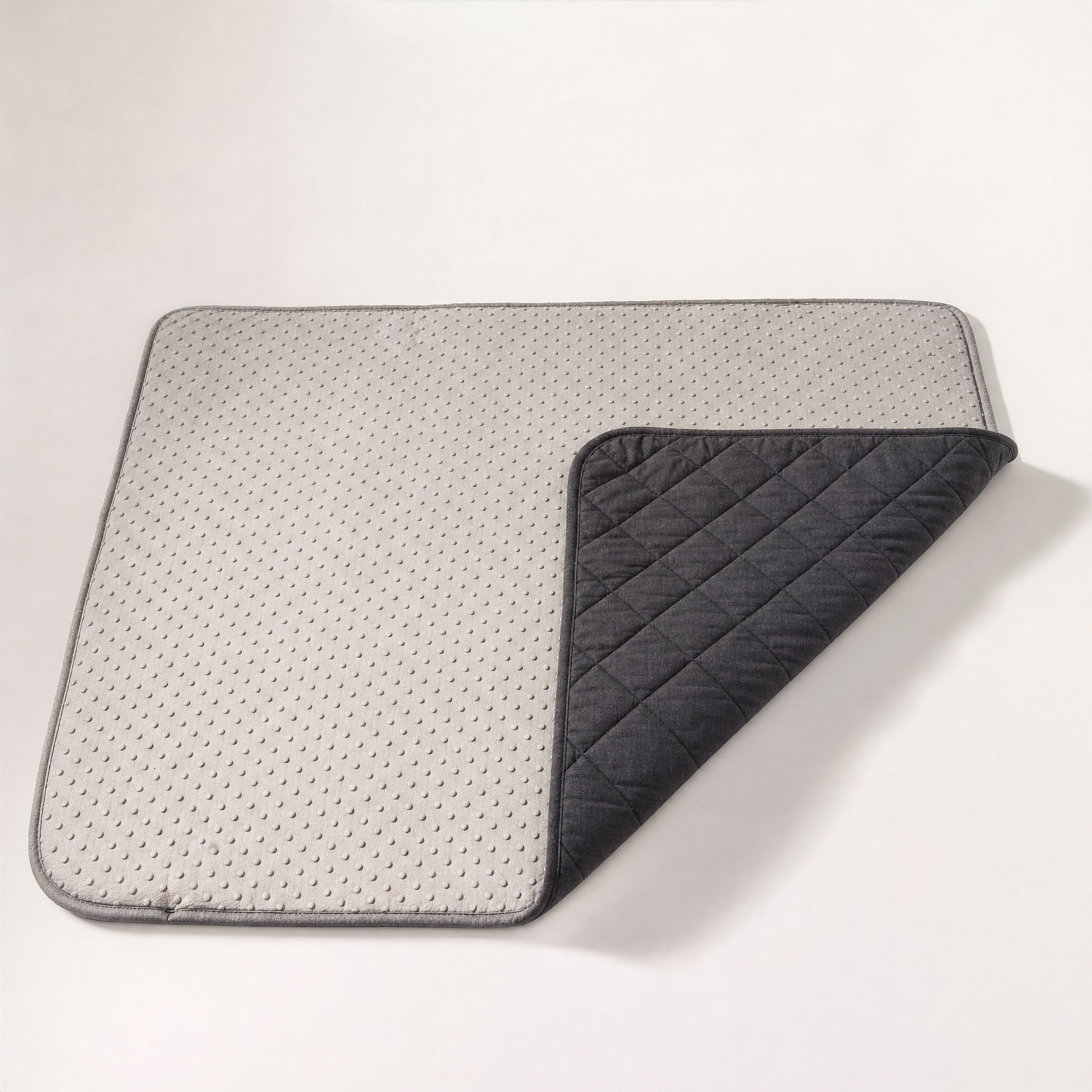 The pale grey backing covered in raised grip dots