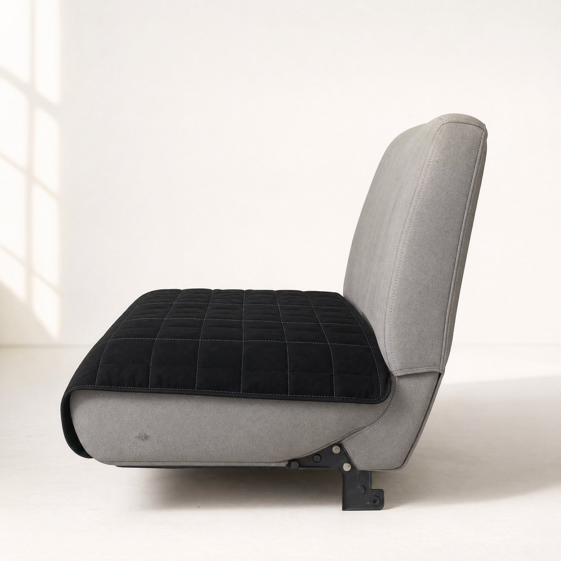 Side view of the pad laid over a bench seat, hanging over the front edge