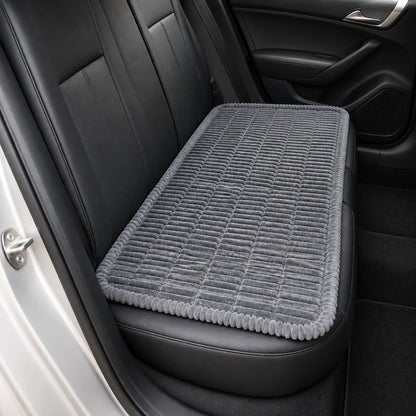 Grey ribbed car-seat dog bed laid across a car back seat